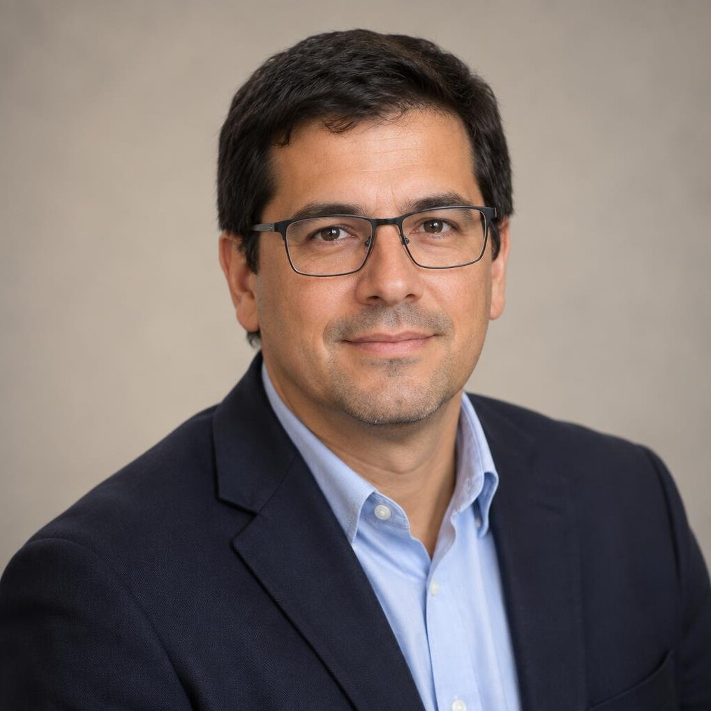 Studio portrait of a Latin American man editor with glasses